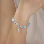 Female model wearing 316L stainless steel feather charm beads bracelet custom ODM Jewelry Manufacturer for major brands