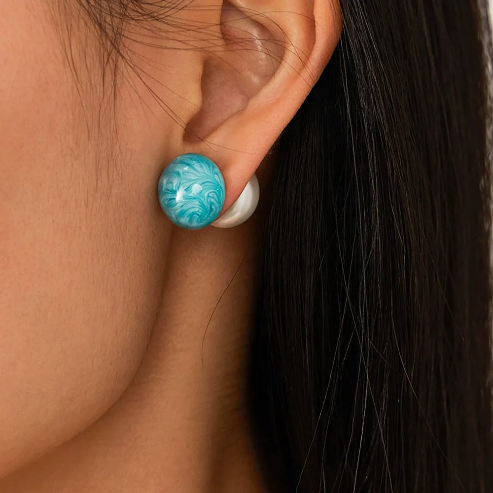Female model wearing stainless steel enamel imitation pearl earrings to showcase fit for emerging designers