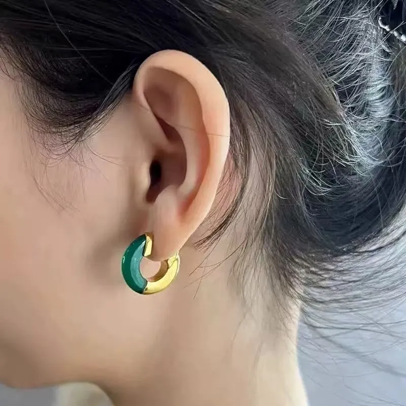 Female model wearing hoop Resin earrings to showcase size and fit for Jewelry Direct Source